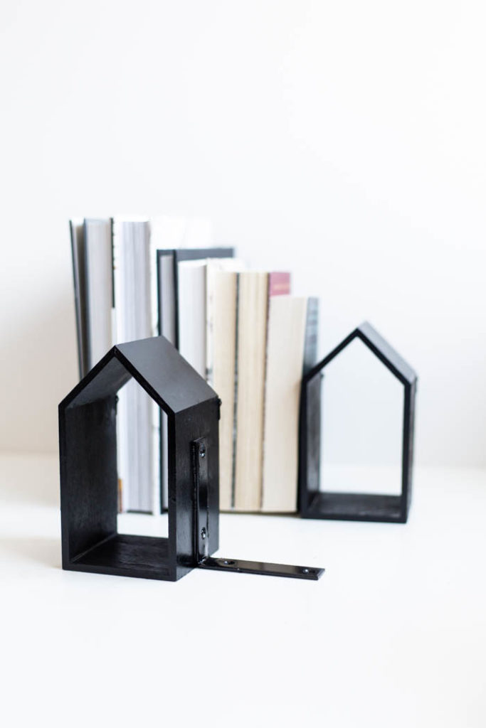 Black bookends full of books