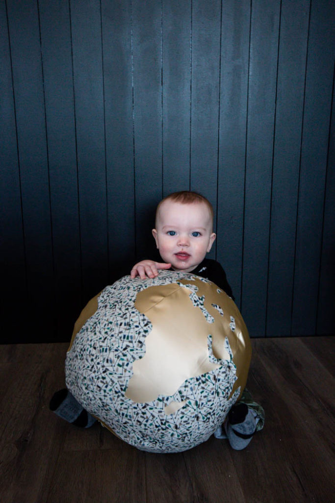 Baby boy with his toy globe