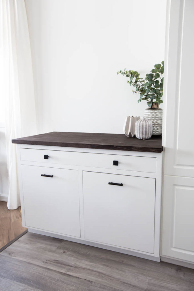 White cabinet with wood top in kitchen