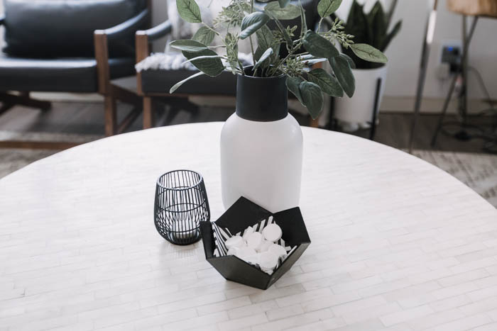 decorative candle, vase, and geometric bowl on coffee table