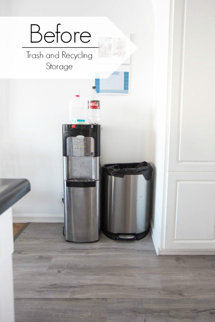 water cooler, trash can, and recycling in the kitchen with text overlay reading "before trash and recycling storage"