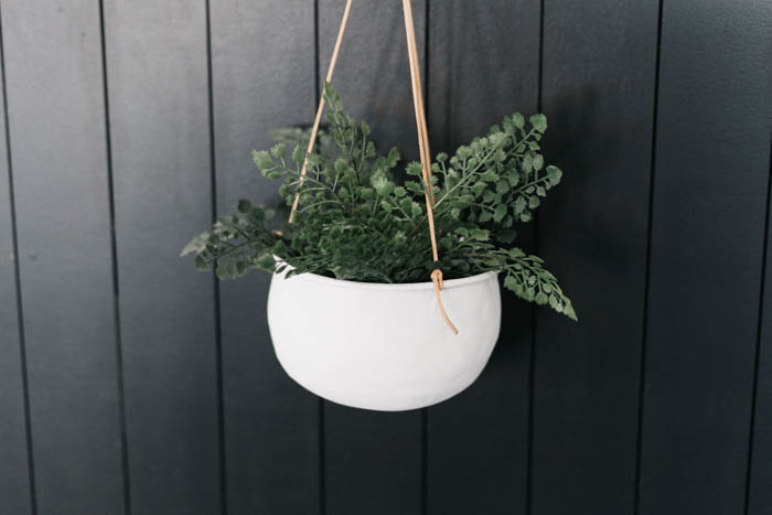 hanging indoor flower pot with black shiplap wall