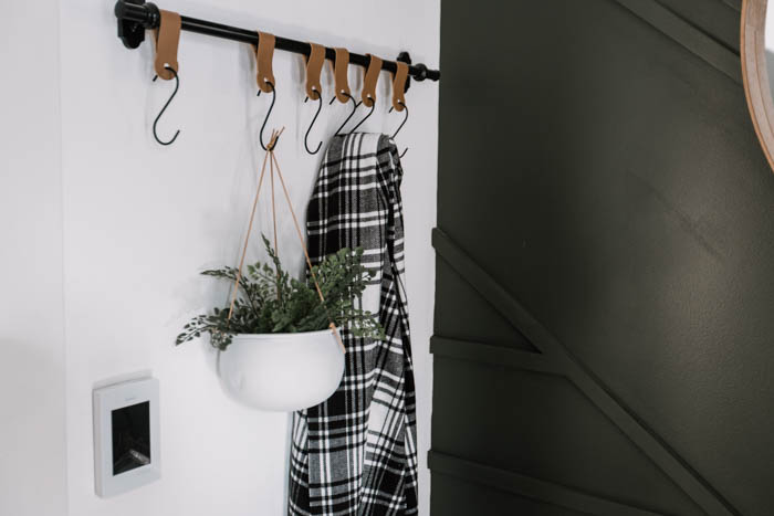 leather hooks and a white hanging planter