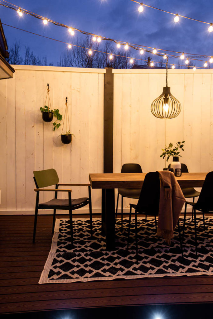 privacy wall and string lights on patio at night