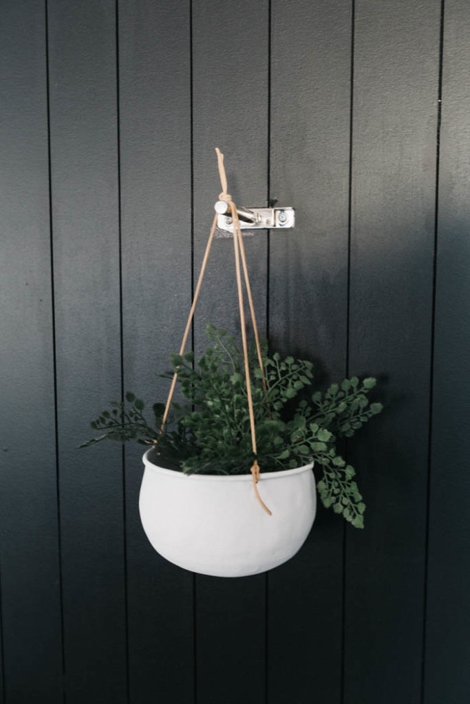 White hanging planter with leather cords