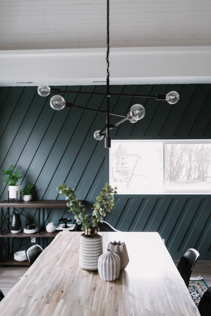 beautiful deep wall in dining room with modern light fixture