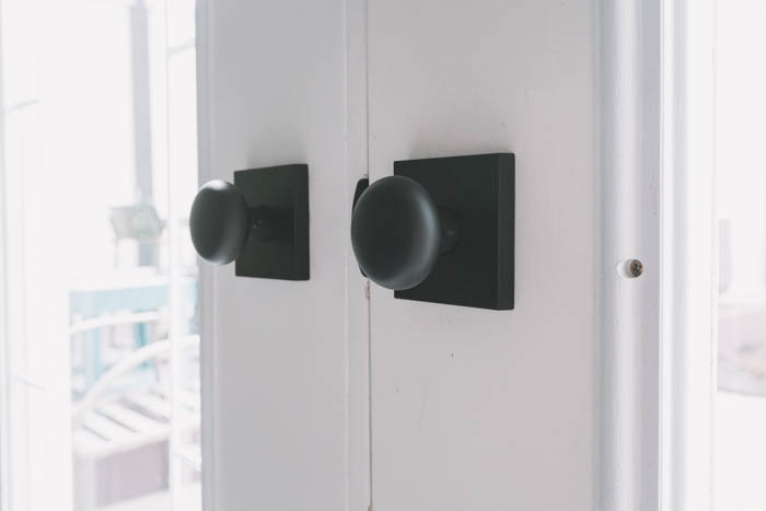 matte black door knobs on a white door