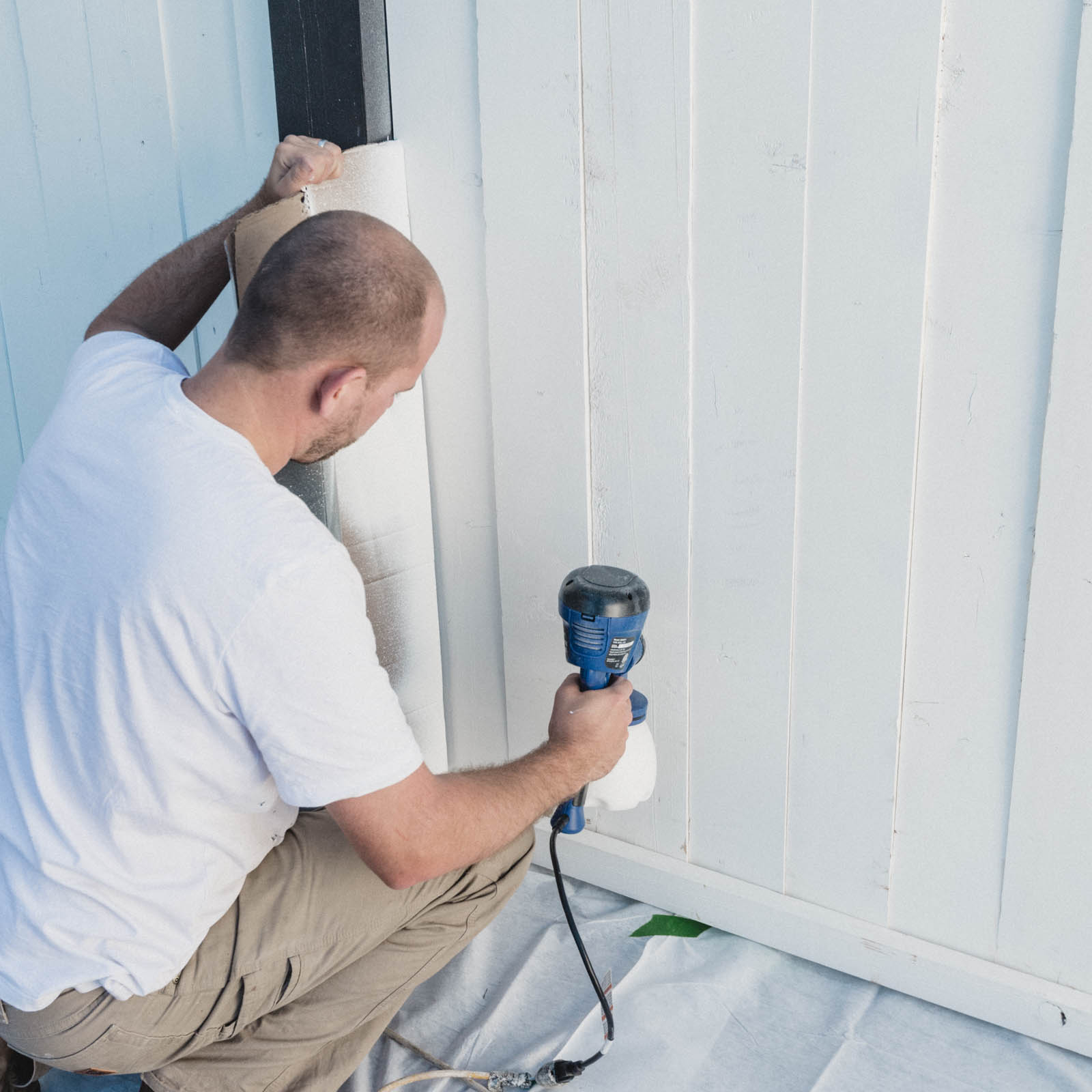 Showing how to paint a wood fence with a paint sprayer