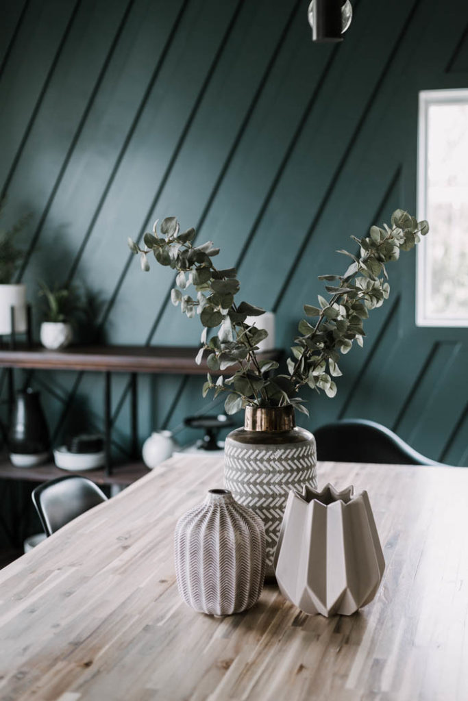 beautiful white washed table with vases and greenery