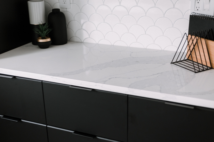 quartz countertop with black cabinets