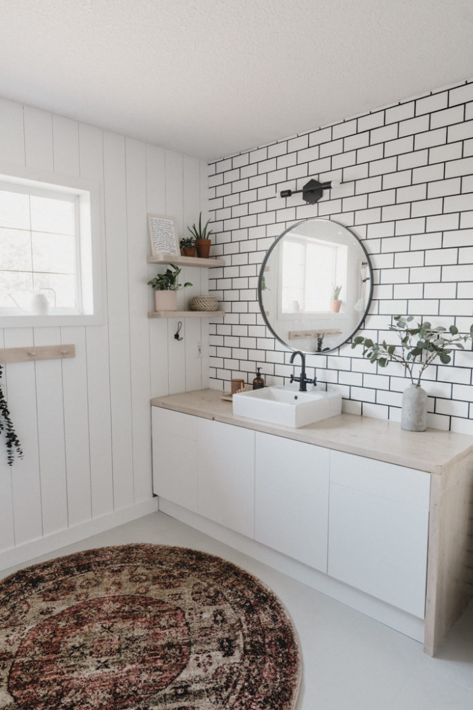 new tiled accent wall in white bathroom