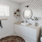 Tiled wall with subway tile in bathroom