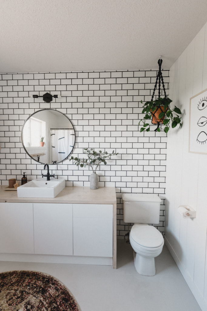 Subway Tile bathroom with white cabinets