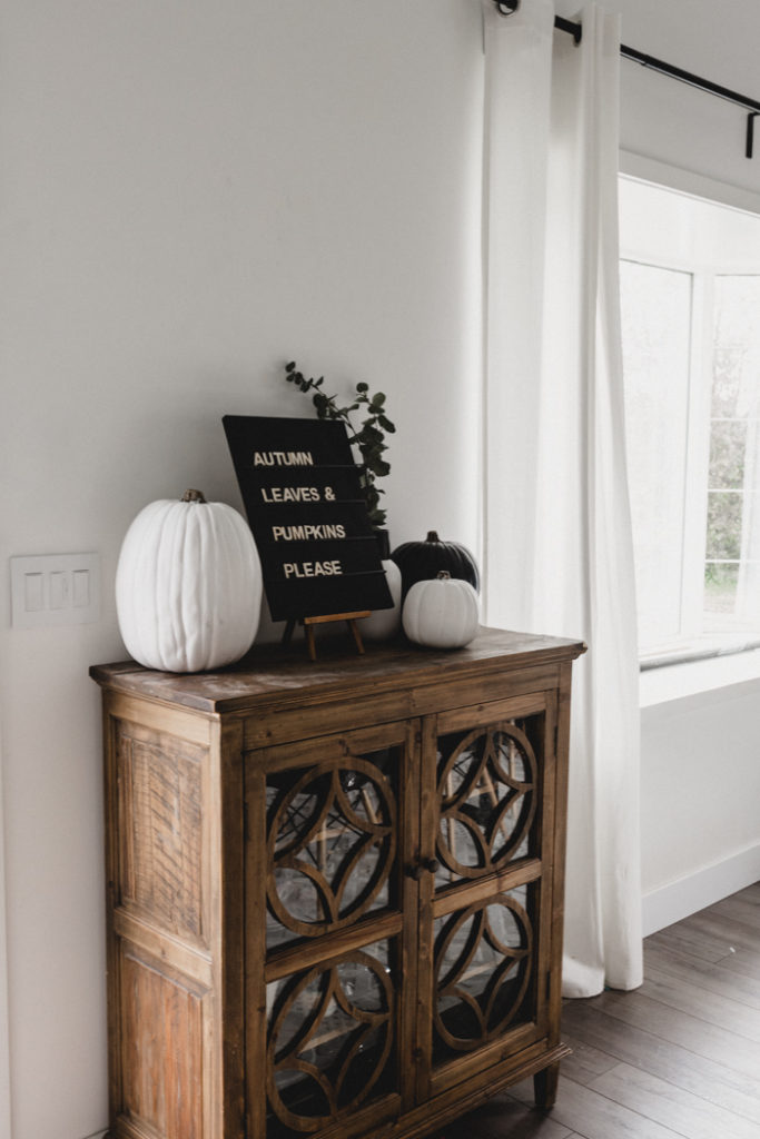 wooden sideboard decorated for fall