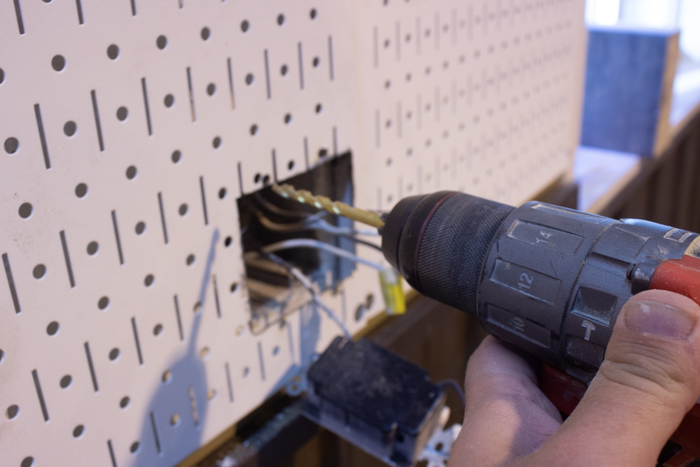 drilling an outlet into metal pegboard