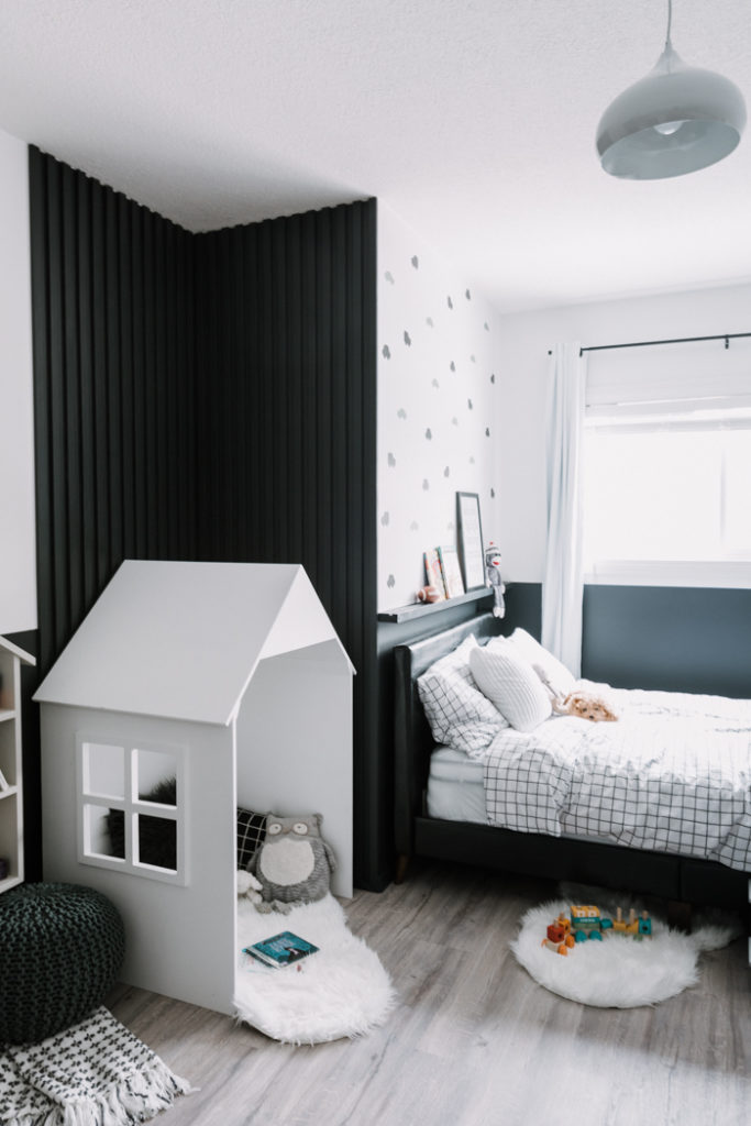 accent wall and little house in modern shared bedroom
