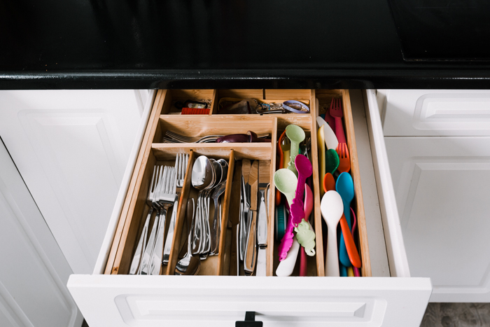 disorganized cutlery drawer before makeover