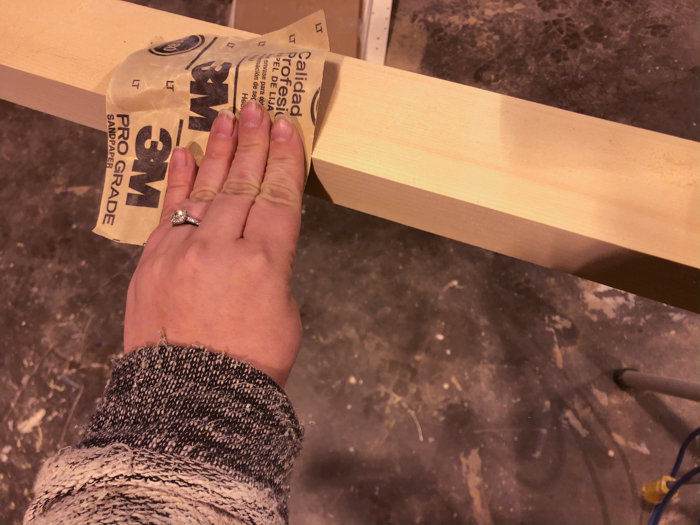 sanding down edges of a pine board