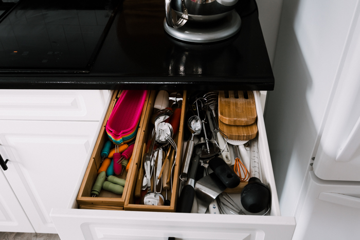 disorganized utensil drawer before makeover