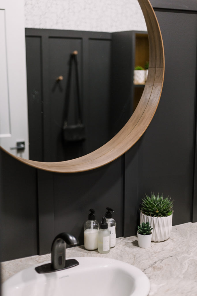 walnut mirror on black board and batten in bathroom