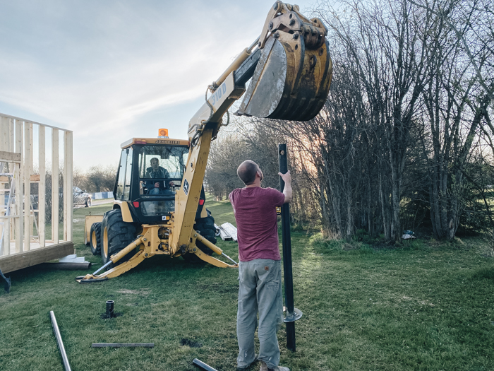 Putting piles into the ground for a playhouse