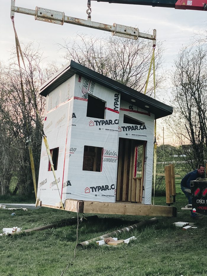 Raising the playhouse with a picker truck