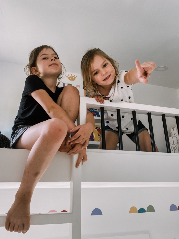 girls in the loft of their playhouse