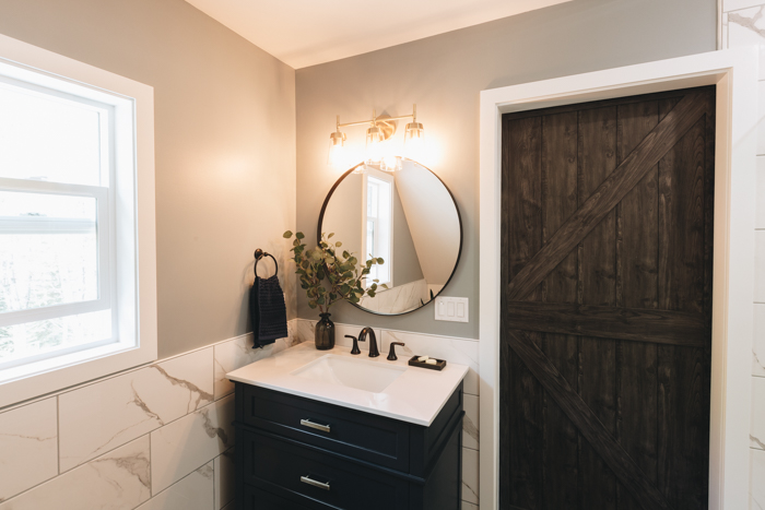 modern farmhouse bathroom with barn door