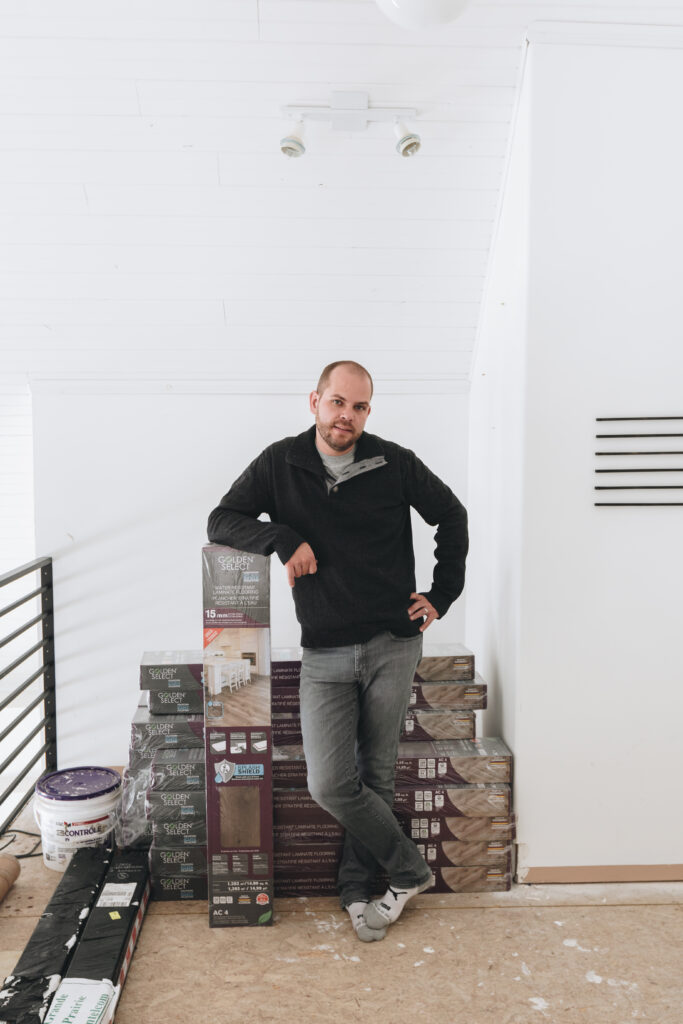 Photo of man with laminate flooring boxes