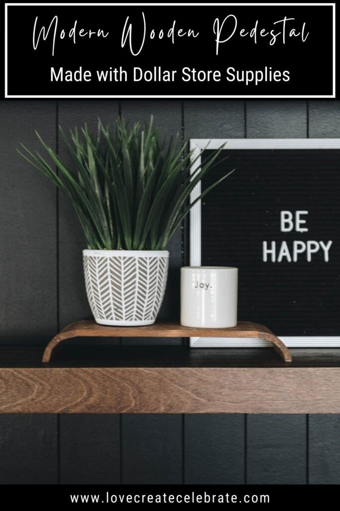 Plant and mug sitting on modern wooden pedestal with text overly