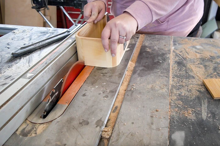 cutting end pieces from wooden shelf to make a modern wooden pedestal