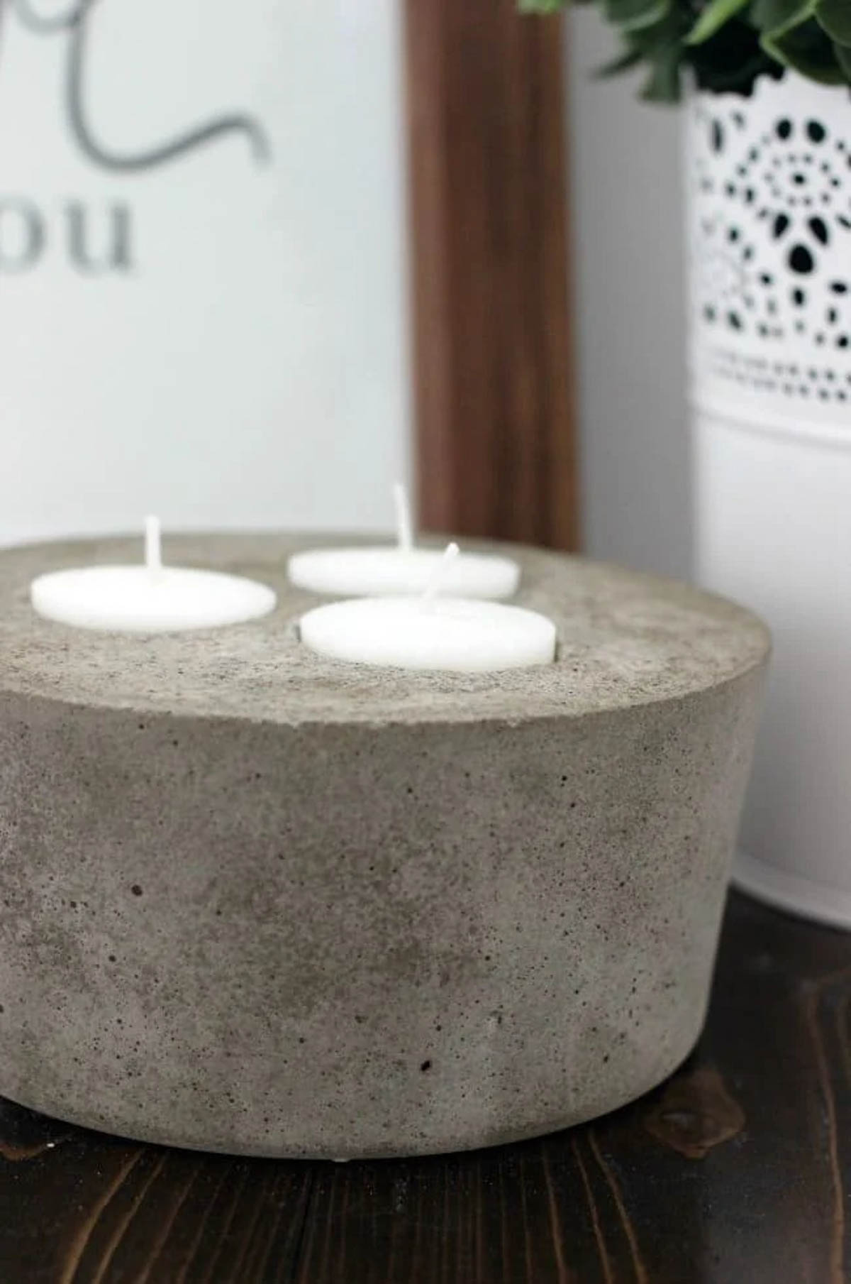 Close up image of 3 tea lights in concrete candle