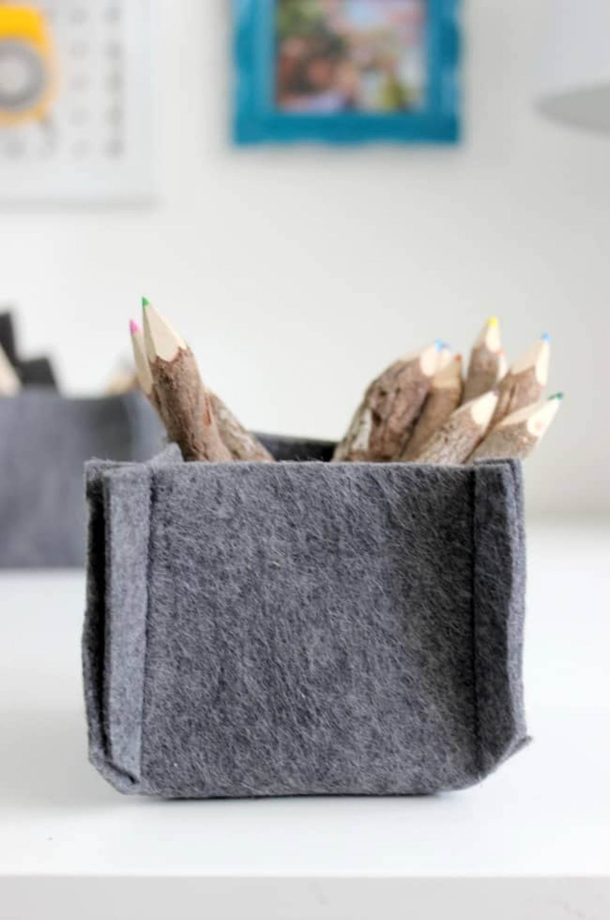 Felt container with wooden colored pencils