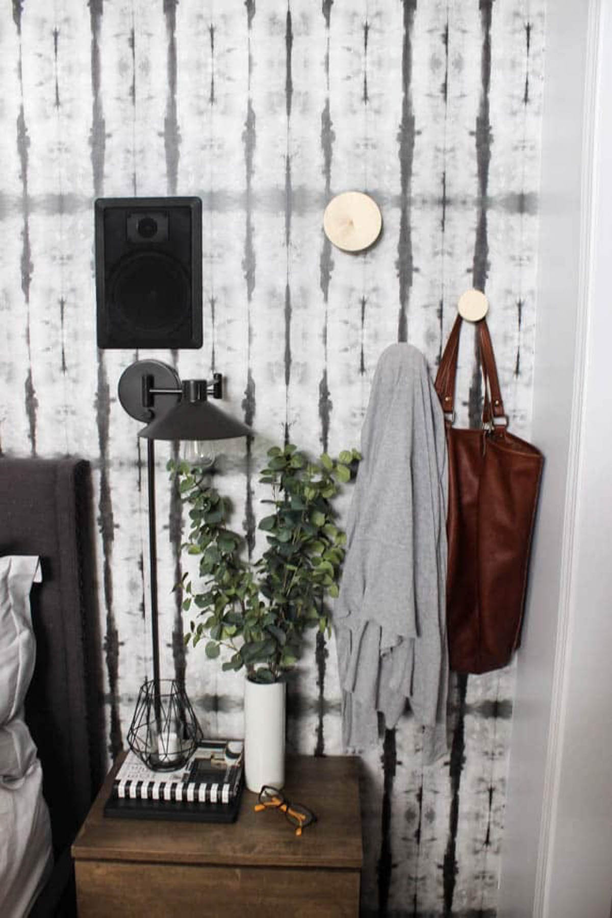 DIY wall hooks holding a bag and sweater
