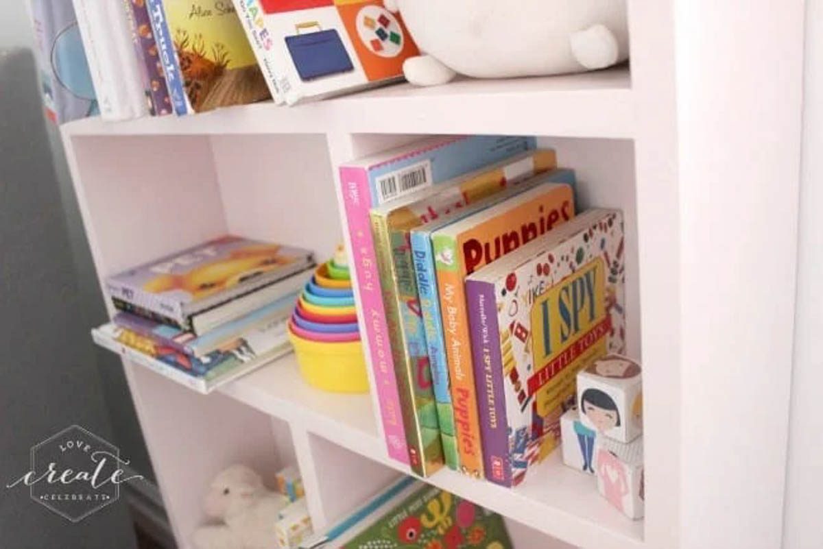 Close up image of books and toys on the house bookshelf