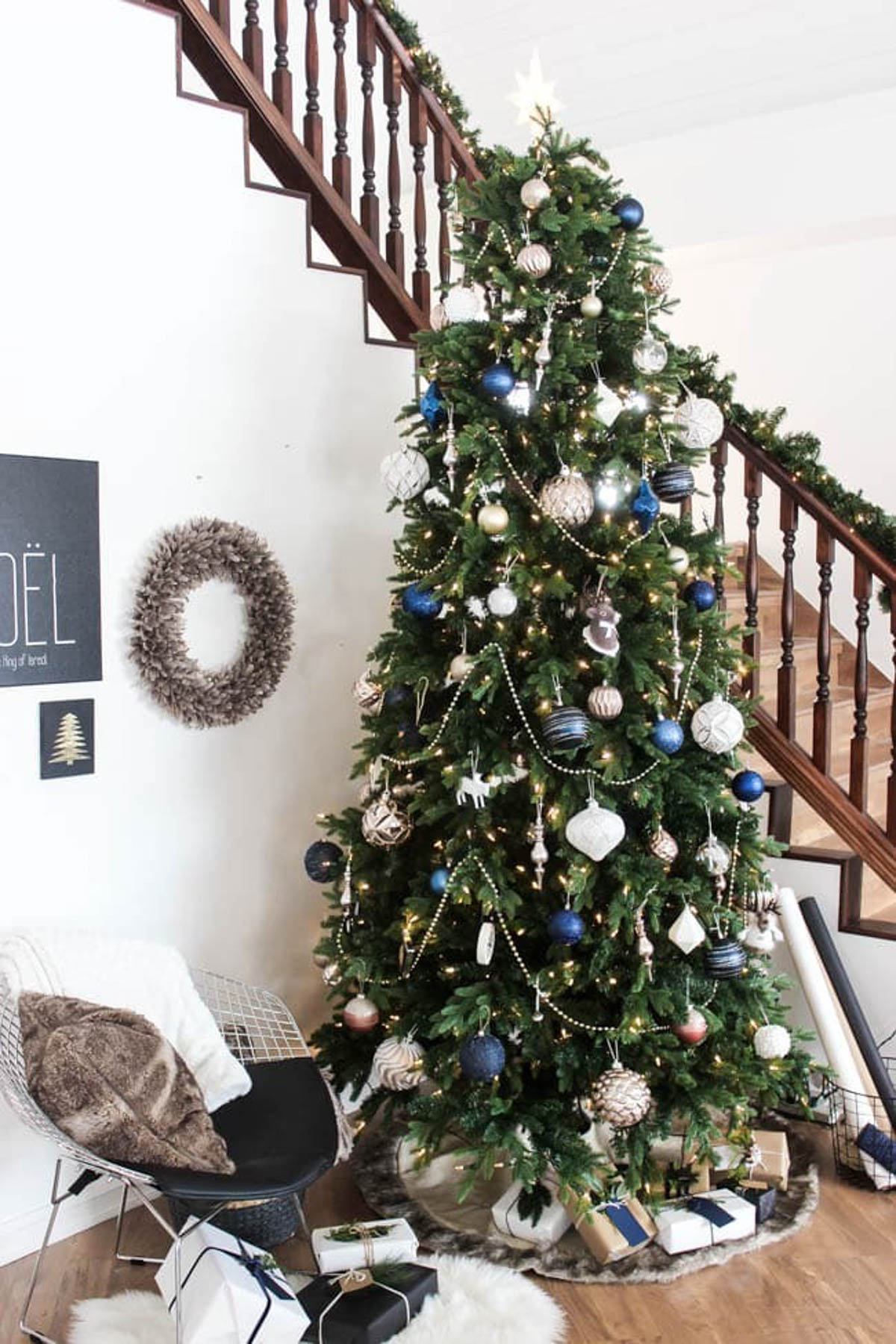 Decorated designer Christmas tree near a banister.