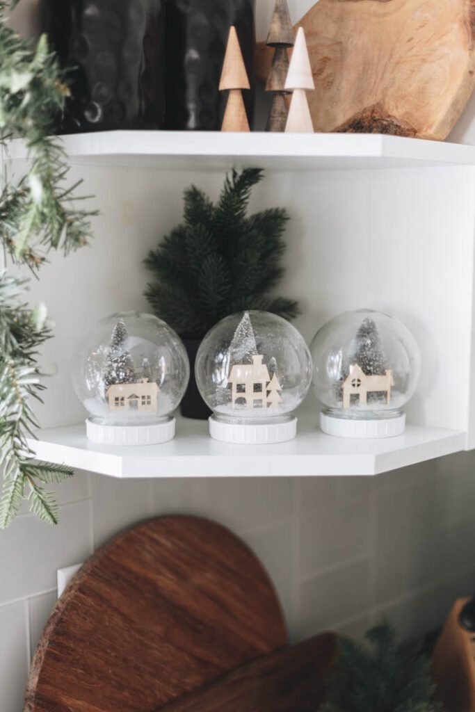 snow globe village sitting on kitchen shelf