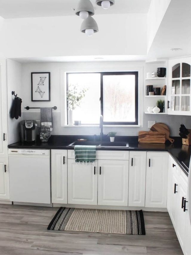 black and white kitchen with black painted window frame