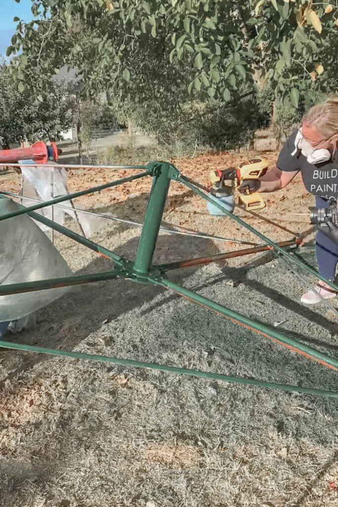 tire swing metal frame getting painted green